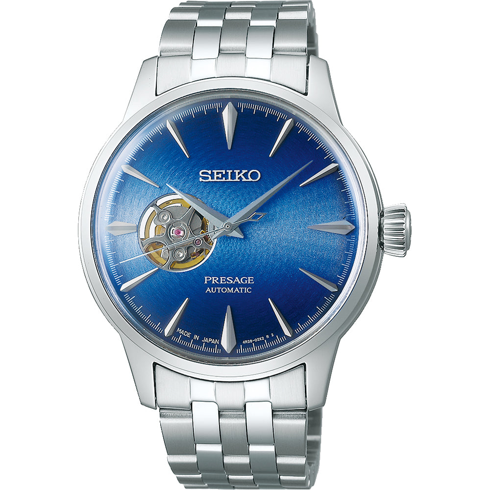 Het Seiko Presage heren horloge SSA439J1 heeft een blauwe sunburst wijzerplaat met een open-heart design, zilveren uurmarkeringen, roestvrijstalen band en gekartelde kroon aan de rechterkant. Het is een elegant stuk voor de Presage-collectie.