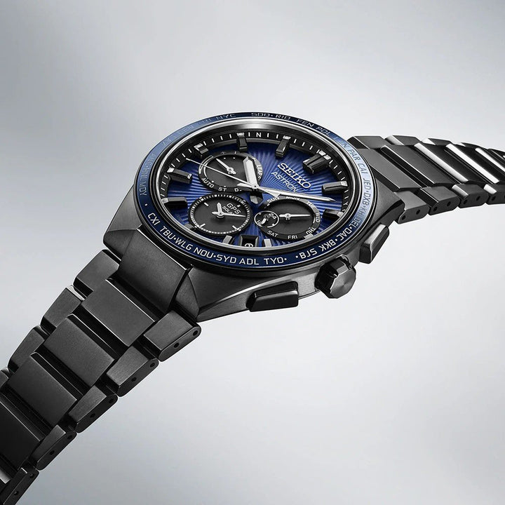 De Seiko Astron herenhorloge SSH121J1 heeft een strakke zwarte metalen band, blauwe wijzerplaat en meerdere wijzerplaten. Het behoort tot de Astron-collectie met een grijze gradiëntachtergrond en robuuste saffierglasbescherming voor geavanceerde functionaliteit.