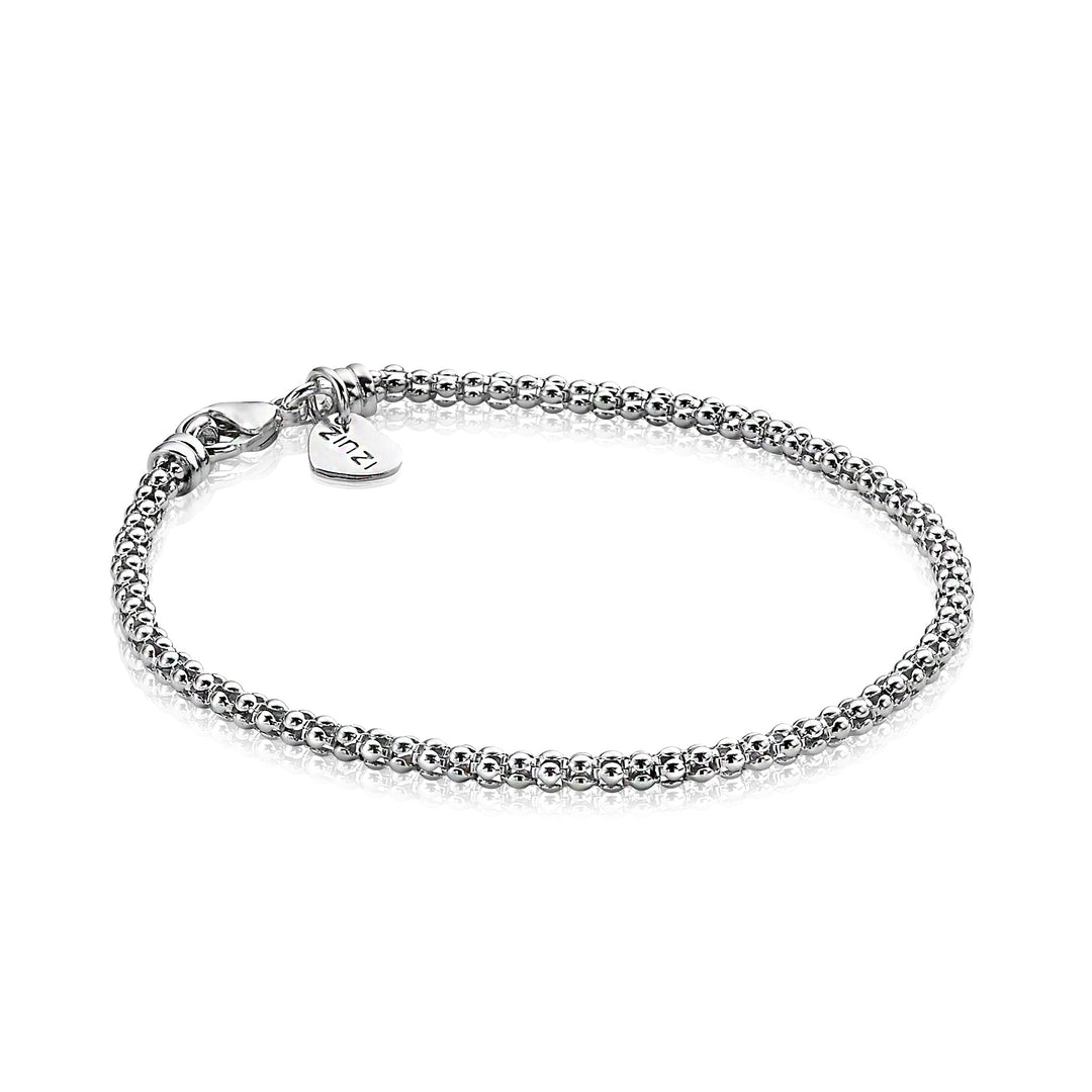 De Zinzi Armband Zilver Zia1288 heeft een karabijnsluiting en een klein rond bedeltje met de tekst Tiffany, elegant weergegeven op een onberispelijk witte achtergrond.