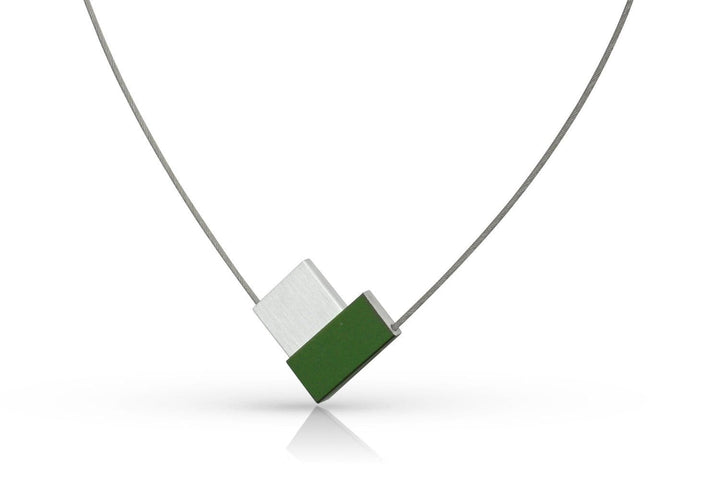 De Collier V-vorm Groen C150GR van CLIC Creations is een minimalistische ketting met een dunne metalen ketting en een uniek ontworpen hanger met overlappende zilveren en groene rechthoeken, handgemaakt in Nederland voor een moderne, strakke look.