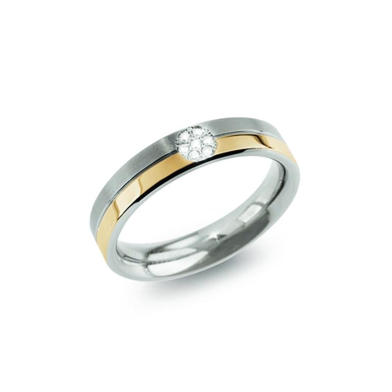 Bicolor Ring aus Titan mit einem weißen Edelstein in der Mitte und goldenen Akzenten