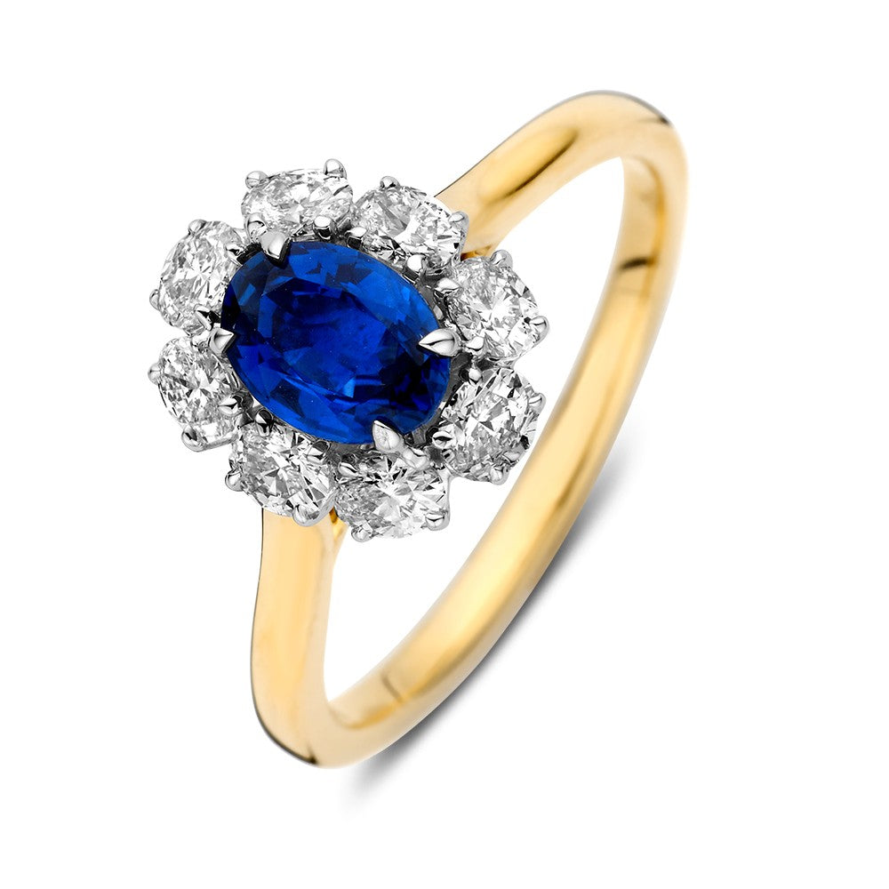 Bicolor Ring mit ovalem blauen Saphir und umgeben von brillanten, gelbvergoldetem Band