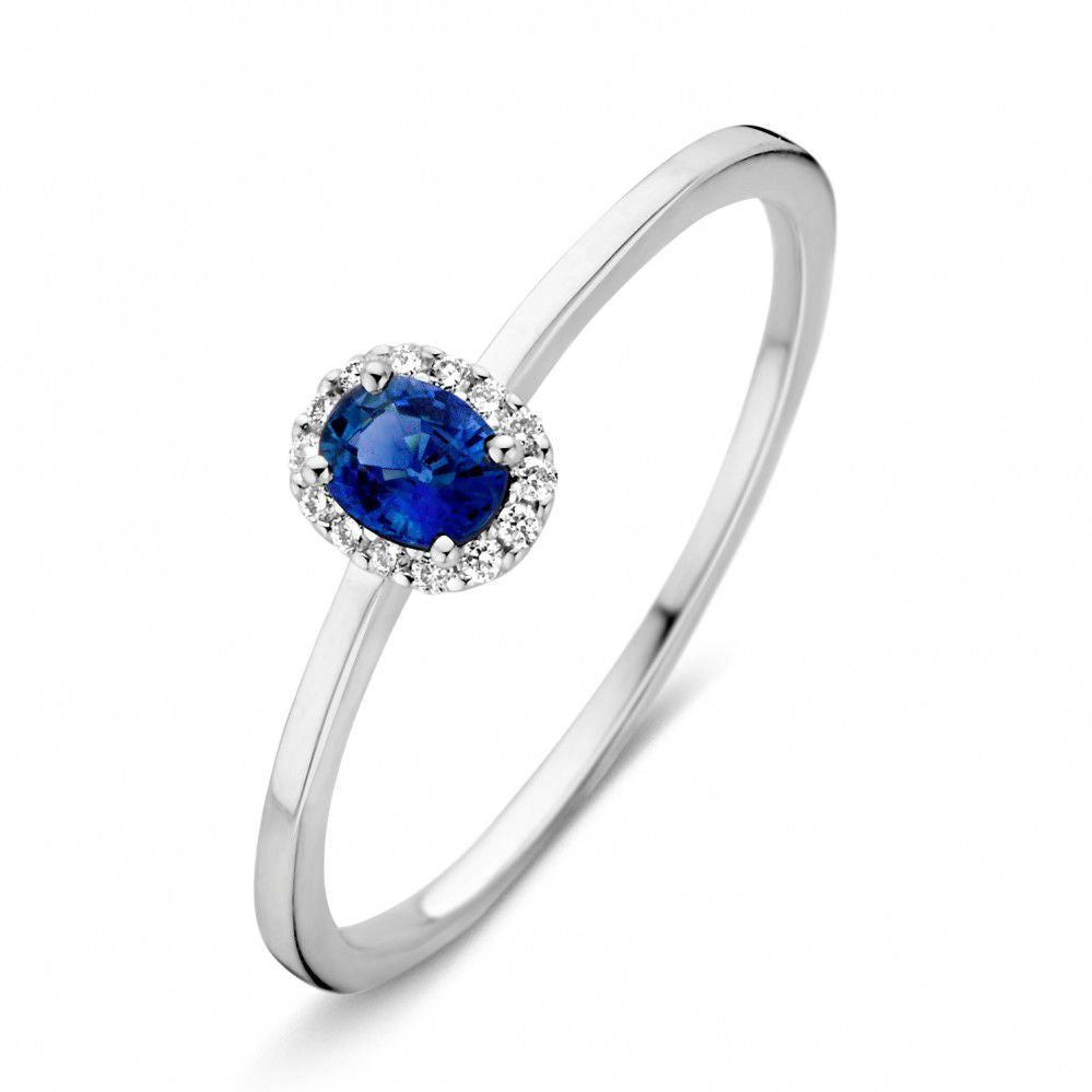 Damenring aus Weißgold mit ovalem blauen Saphir und diamantbesetztem Rahmen