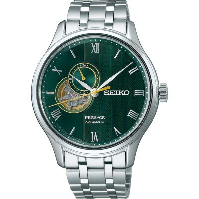 Automatische Uhr mit grünem Zifferblatt, silbernem Gehäuse und Armband, sichtbarem Uhrwerk und römischen Ziffern