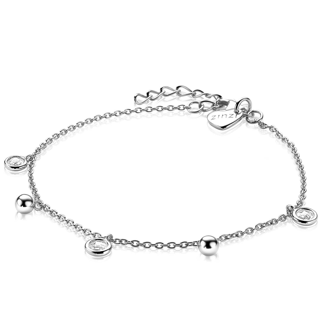 De Zinzi Armband Zilver Zia2192 van Zinzi is een delicate zilveren schakelarmband met kleine ronde bolletjes bedels met witte zirkonia stenen. Het heeft een verstelbare ketting die eindigt in een hartvormig label, wat een elegant en eenvoudig ontwerp biedt dat geschikt is voor elke gelegenheid.