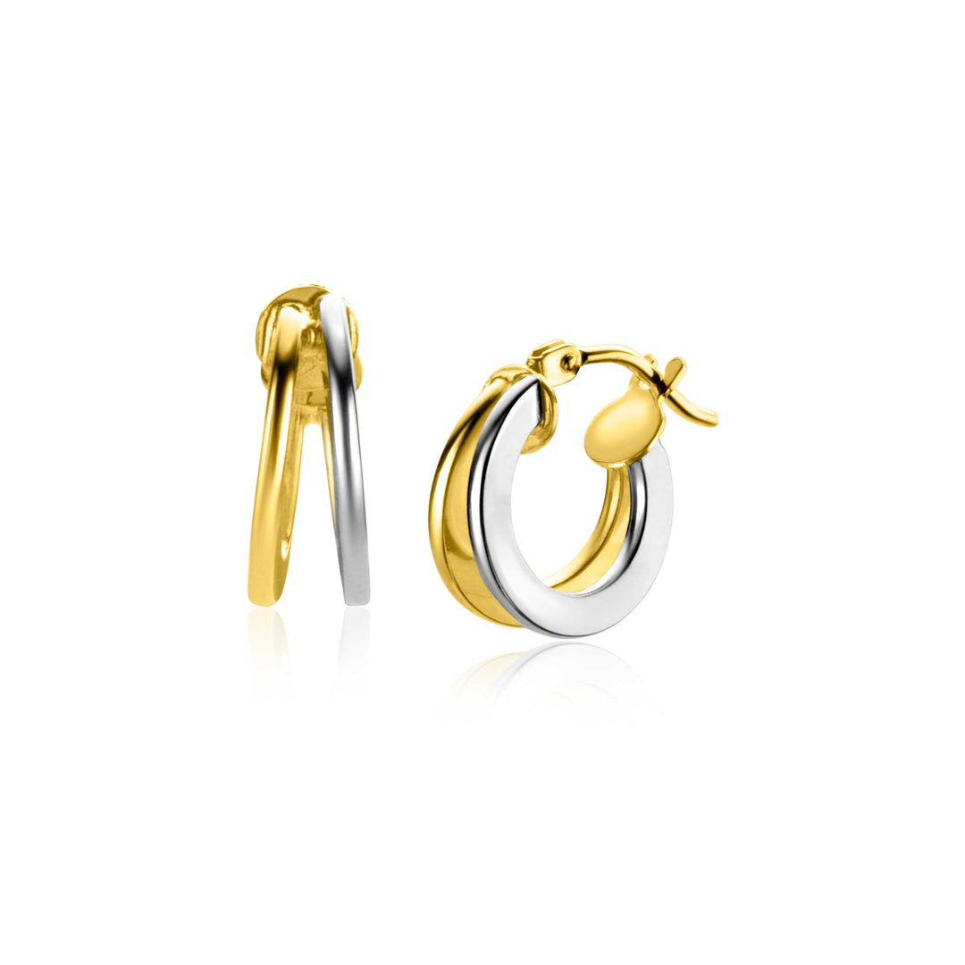 Deze stijlvolle Zinzi Oorbellen Goud Zgo337 B bicolor creolen combineren goud en zilver in een glad, afgerond ontwerp. Hun gepolijste, reflecterende oppervlak en veilige sluiting geven ze een strakke, moderne uitstraling.