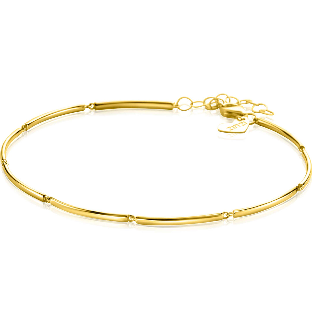 De Zinzi Armband Goud Zga461 is een strakke 14k gouden armband met onderling verbonden gebogen staafjes en een klein hartvormig bedeltje bij de sluiting. Tegen een effen witte achtergrond belichaamt dit stuk elegantie en verfijning.