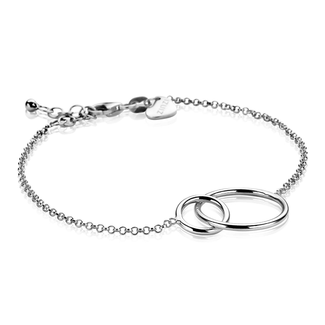 De Zinzi Armband Zilver Zia1278 heeft twee in elkaar grijpende ringen aan een delicate ketting, inclusief een verstelbare sluiting en hartbedel.
