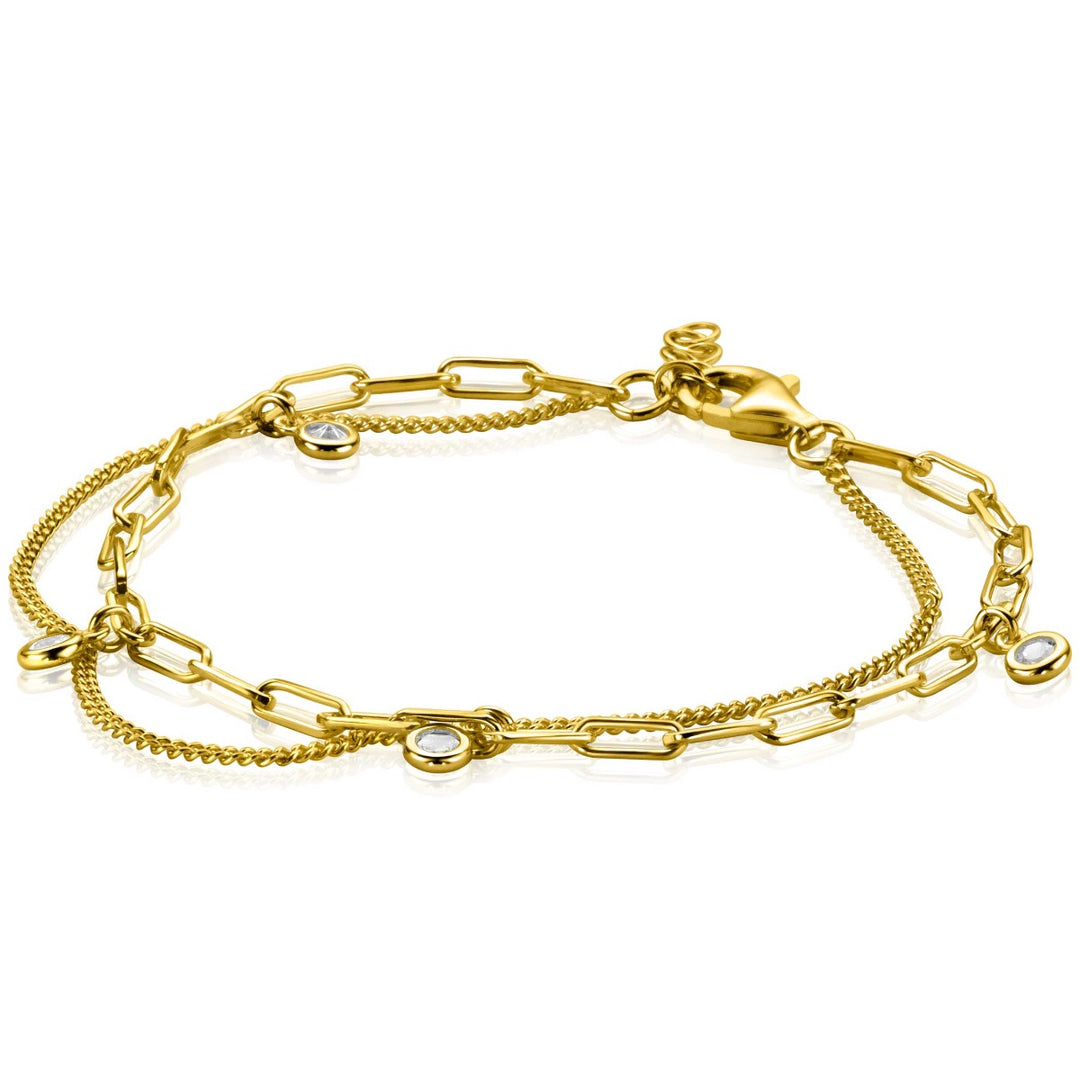 De Zinzi Armband Gold Plated Zia2362 Y is een verguld meesterwerk met een delicaat schakelontwerp versierd met glinsterende zirkonias, met in elkaar verweven schakeltypes en een karabijnsluiting voor een elegante uitstraling.
